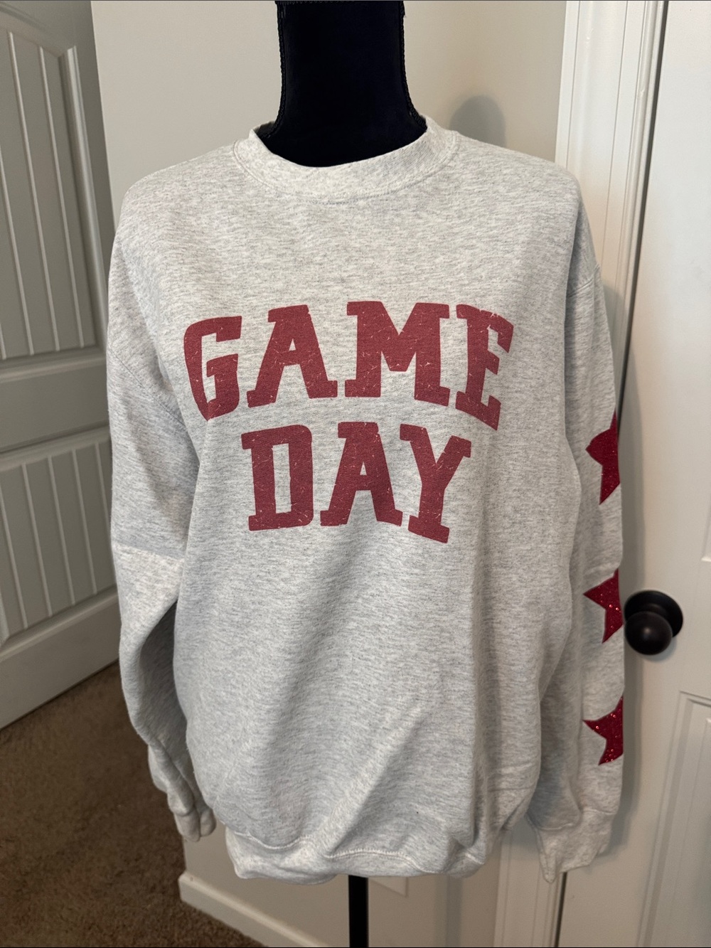 Distressed Vintage Couture Game Day sweatshirt with red stars on sleeves. Size M